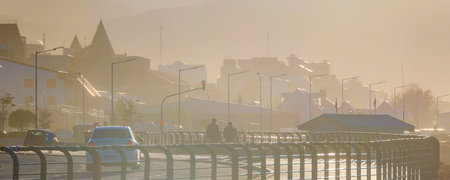 Highway and waterfront buildings at misty morning day, Ushuaia, Tierra del Fuego, Argentinaの写真素材