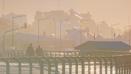 Highway and waterfront buildings at misty morning day, Ushuaia, Tierra del Fuego, Argentinaの写真素材