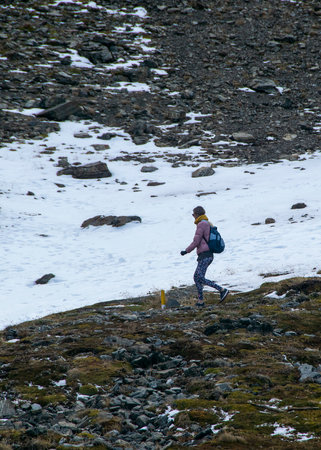 Woman walking trough path at martial glacier, ushuaia, Tierra del Fuego, Argentina