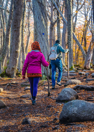 Couple walking at Laguna Esmeralda hiking trail, Tierra del Fuego province, Argentinaの写真素材