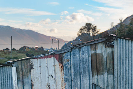 Poor sheet metal house and landscape at background, Puerto Almanza, Tierra del Fuego, Argentinaの写真素材