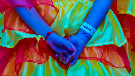 Back view long distant zoom closeup shot woman with colorful custome dress at calls parade carnival, Montevideo, Uruguayの写真素材