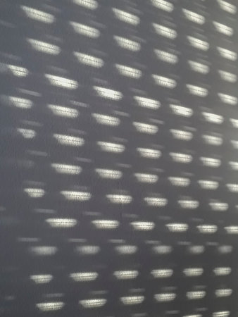 Curtain pattern created by light and curtains over interior bedroom wall