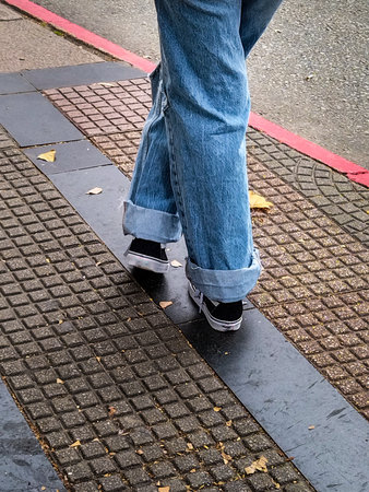 Teen woman with jeans at urban street waiting for bus, Montevideo city, Uruguay