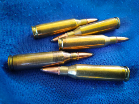Top view shot new shotgun cartridges over blue fabric background