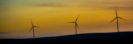 Windmills at steppen high contrast silhouette landscape, viedma department, chubut province, argentinaの写真素材