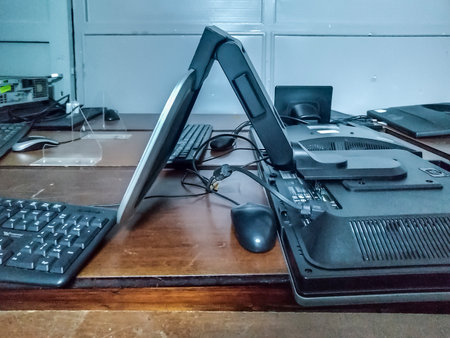 High angle shot computer equipments over wooden table at roomの写真素材