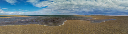 Low tide empty beach landscape at one of the san antonio oeste town beaches, rio negro province, argentinaの写真素材