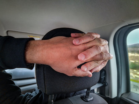 Copilot  adult man with hands intertwined behind copilot car seatの写真素材