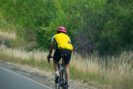 Biker driving at outdoors highway near los alerces national park, chubut province, patagonia, argentinaの写真素材