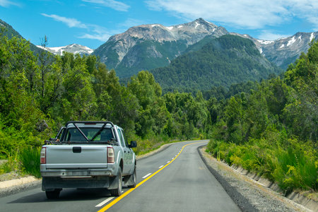 Highway surrounded by forest landscape at los alerces national park, a world heritage site located in chubut province, patagonia, argentinaの写真素材
