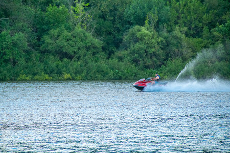 Man at jet ski sailing fast at santa lucia river, los cerrillos, canelones department, uruguayの写真素材