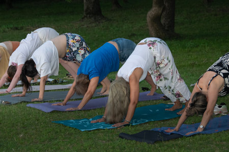 Heterogeneous women small group practicing kundalini yoga at border of river, santa lucia river, los cerrillos, canelones department, uruguayの写真素材