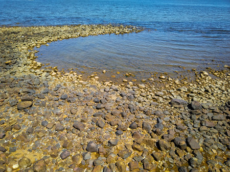 Wide shot of rocky coastilne beach at a summer morning day at piriapolis city, maldonado department, uruguayの写真素材
