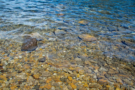 High angle view transparent rocky beach detail at nahuel huapi lake,  nahuel huapi national park, san carlos de bariloche, rio negro province, patagonia, argentinaの写真素材
