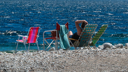 People at sunny summer day at one of the beaches of bariloche, nahuel huapi national park, rio negro province, argentina.の写真素材