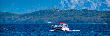 Boat crossing waters of nahuel huapi national lake, bariloche,  rio negro province, patagonia, argentina.の写真素材