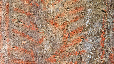 Ancient petroglyphs symbols drawing close-up at rock at los altares plateaus, chubut province, argentinaの写真素材