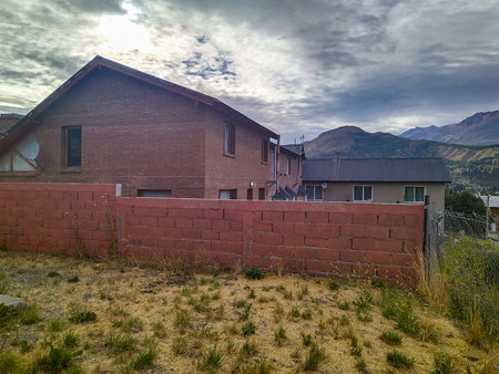 Rustic houses at steppe environment at residential neighborhood, esquel city, chubut province, argentinaの写真素材