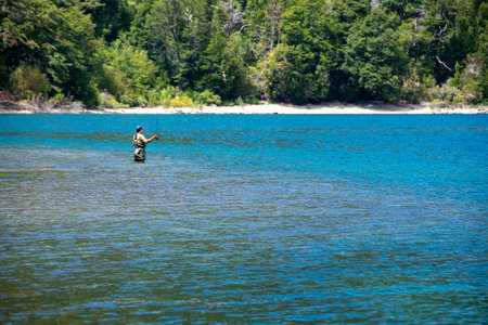 Adult man fishing in lake, los alerces national park, chubut province, argentina,の写真素材