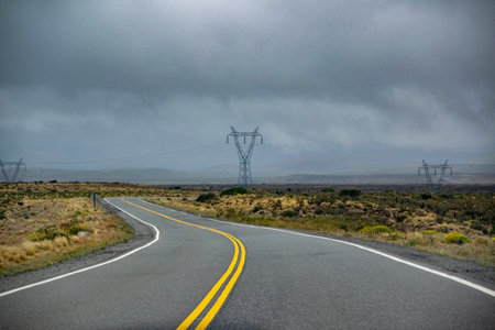 Empty modern highway crossing steppe patagonia landscape, chubut province, argentinaの写真素材