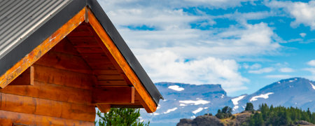 Rustic rural style house and patagonia landscape at background, los alerces national park, a world heritage site located in chubut province, patagonia, argentinaの写真素材