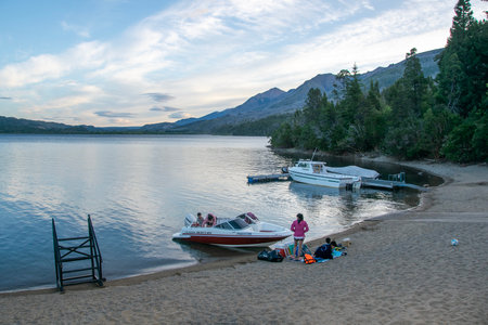 Futaleufu, Argentina: January 8 2023: Family with motorboat at border of lake, los alerces national park, a world heritage site located in chubut province, patagonia, argentinaの写真素材