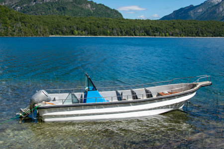 Futaleufu, Argentina: January 8 2023:  Small motorboat in the coast of lake, los alerces national park, a world heritage site located in chubut province, patagonia, argentinaの写真素材