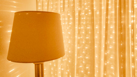 Interior scene depicting closed curtains of apartment living room iluminated by the sun of the...