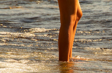 Young woman at shore of lakeの写真素材