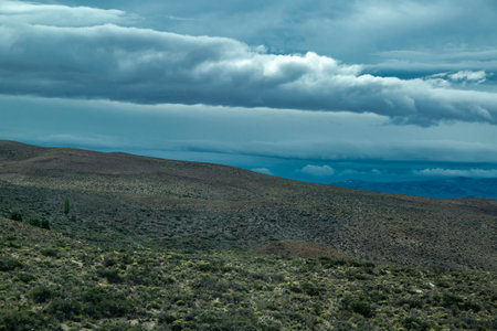 Andes mountains covered by big white clouds at top, chubut province, argentinaの写真素材