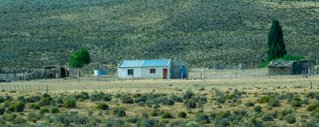 Rustic countryside house surrounded by the vast patagonian steppe in cushamen department, chubut province, argentinaの写真素材