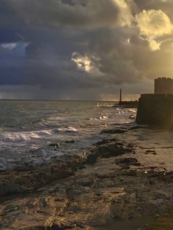 Summer sunset urban coastal scene at boardwalk in the famous la rambla de montevideo, ciudad vieja...