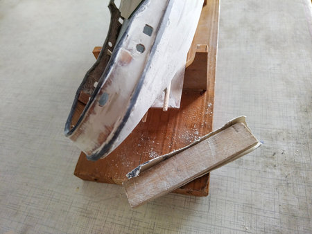 HIgh angle view of handcrafted wooden model of a sailboat under construction.の写真素材
