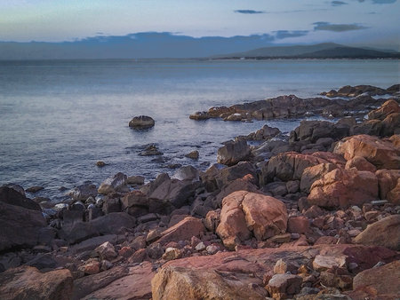 Front view wide shot of a rocky coastal shoreline during afternoon at piriapolis city, maldonado department, uruguayの写真素材