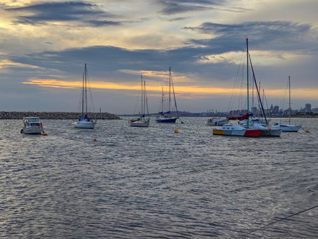 Wide shot sailboats at harbor during sunset, montevideo city, uruguayの写真素材