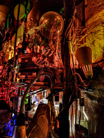 Vibrant bar interior filled with multicolored bottles and neon lights.の写真素材