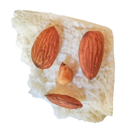 A high-angle, close-up shot of a creative food item, possibly a piece of bread or pastry, shaped to resemble a ghost or a screaming faceの写真素材