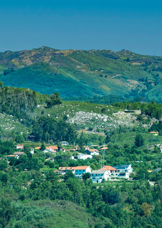 High-angle shot of a picturesque mountain village with houses clustered on forested slopes, fafe, braga district, portugalの写真素材