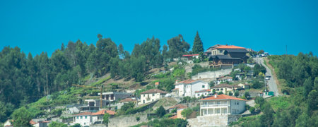 High-angle shot of a picturesque mountain village with houses clustered on forested slopes, fafe, braga district, portugalの写真素材