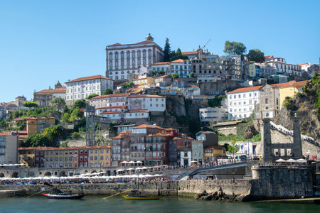 Porto, Portugal: August 12 2023: Front view shot of historic waterfront buildings at ribeira...