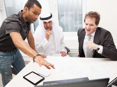 Young architect showing his project to business partnersの写真素材