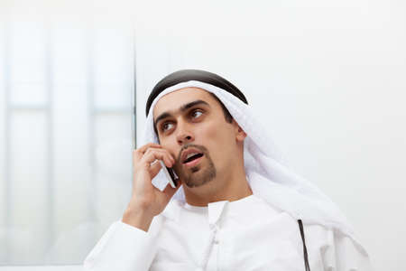 Portrait of a Middle Eastern businessman on the phoneの写真素材