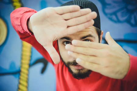 Young man  dances with a graffiti in the backgroundの写真素材