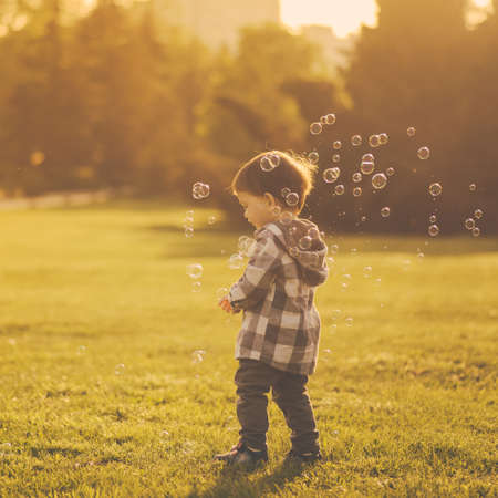 Mom and son have fun and make balloons from soapの写真素材