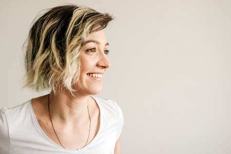 Beautiful young girl with short hair is smiling.