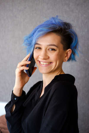 The blue-haired girl speaks on the phone