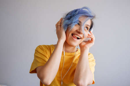 Rock style woman with headphones listening to musicの写真素材