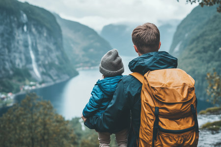 Back view of young couple with backpacks looking at fjord in Norwayの素材