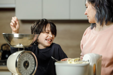 Mother and daughter cooking together in the kitchen at home. Concept of a happy family.の写真素材